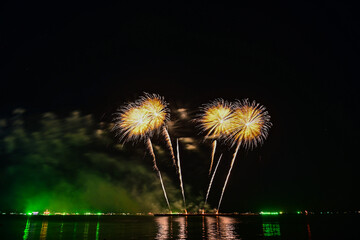 Beautiful fireworks set off in the middle of the sea.