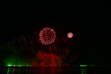 Beautiful fireworks set off in the middle of the sea.