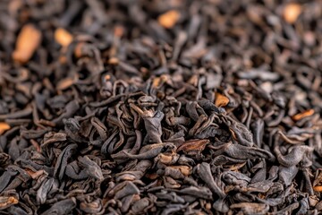 Fototapeta premium Black tea leaves displayed in a close-up view showcasing their rich texture and color in a natural setting