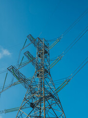 Overhead Power Lines Against Blue Sky Background