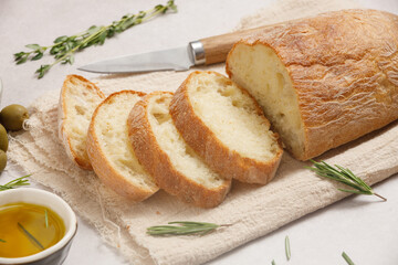 Fresh sliced ciabatta with olive oil on an ancient cutting boarda
