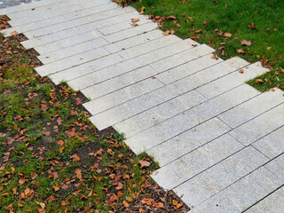 flat stones in the garden form a footpath with a bed mulched with bark chips. stepping stones in...