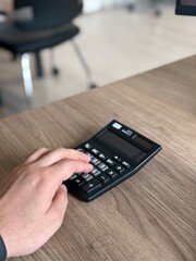 a person doing math on a calculator by hand
