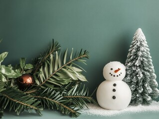 Snowman and Christmas tree. Snow on a green background, minimalist Christmas elements, copy space.
