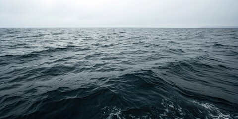 Fototapeta premium Dark waters with subtle ripples and waves, fluid motion, dark water, gentle lapping, luminous hues