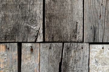 Old paint cracked and peeling on wooden board, decayed paint texture