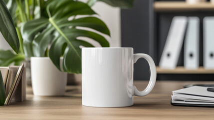 "Stock photo of a mockup mug placed in an office setting with various office objects in the background, complemented by a stylish monstera leaf. Ideal for workspace, branding, or personalized mug 