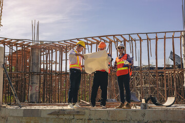 Structural engineer or architect and foreman worker with blueprints discuss, plan working for the...