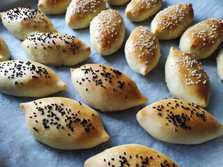 Baked delicious oriental pies with filling, sprinkled with fragrant seeds