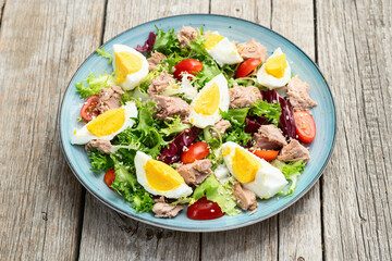 Canned Tuna salad with eggs and tomatoes photography . Top view