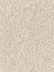 Fototapeta premium A close-up texture of white grains, showcasing the details and patterns of these small, round seeds ready for cooking.