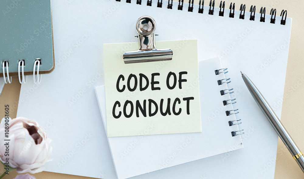 Poster code of conduct text written on page, red pencil on the right.