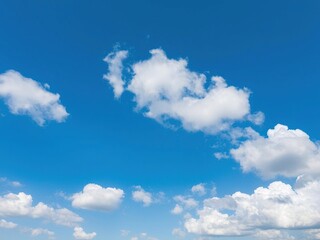 vast blue sky with fluffy white clouds floating gently across it, cloudy day, sunny weather, expansive view