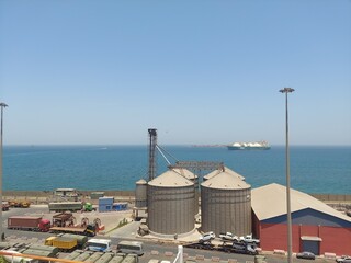 dakar senegal apr 22 2024 Industrial Port View With Storage Silos and Cargo Ship © Anish