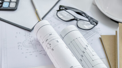 Construction drawings with tools on wooden table isolated on white background