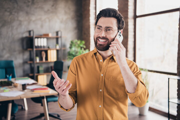 Photo of nice young male talk phone deal wear yellow shirt formalwear coworking successful...