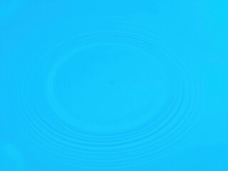 Delicate abstract design featuring water ripple effects on a bright blue background, light rays, reflective pools, blue hues