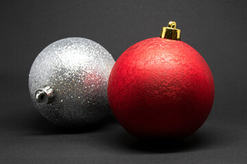 Red and silver ornaments on a dark background