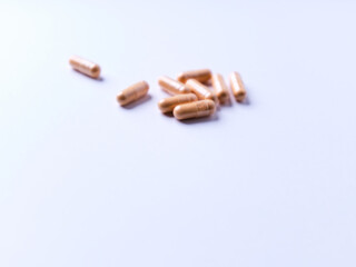 Lutein capsules. Dietary supplement on bright background. Soft focus. Close up. Copy space.	