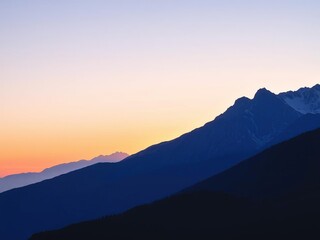 Soft watercolor mountain range at sunset, calming image, gentle gradient