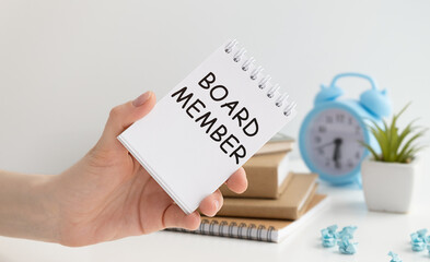 Businessman holding a card with text board member