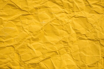 Distressed yellow background with crumpled texture, paper background, worn paper, kraft paper, parchment paper, aged paper