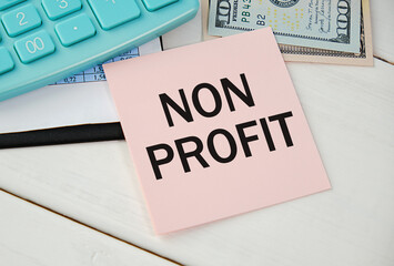 On the financial document near the blue notebook, there is a stationery tablet on which it is written non-profit organization