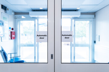 Shallow focus of closed automatic doors located at a typical NHS outpatients hospital in Britain....