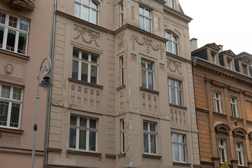 An elegant historic building showcases its intricate architectural details and boasts multiple windows, contributing to the beauty of the surrounding cityscape and enhancing the overall environment