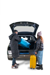 Couple Loading Suitcase into Car Trunk for Winter Travel