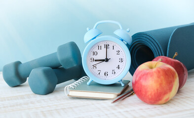 Alarm clock with sports items. The concept of time to go in for sports