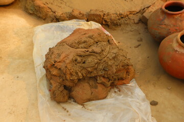 Preparing clay for making traditional pots like kulhad, katori, and diya, highlighting the initial...
