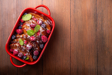 Christmas Morning French Toast Baking, holiday morning french toast casserole, sweet simple dessert with bread, egg and milk mixture and fresh berries