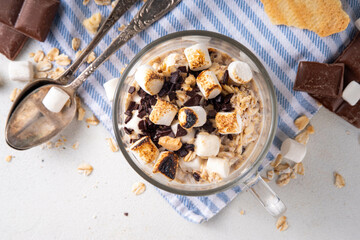 Overnight s`mores oatmeal, Christmas, winter holiday tasty breakfast healthy idea with oats, yogurt, marshmallow, chocolate and creamy sauce