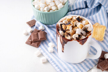 Mug with S`mores hot chocolate or coffee, thick smores hot cocoa or latte drink with toasted marshmallow, graham cracker and chocolate topping