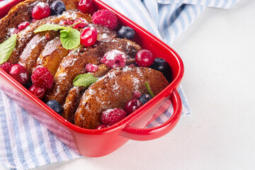 Christmas Morning French Toast Baking, holiday morning french toast casserole, sweet simple dessert with bread, egg and milk mixture and fresh berries