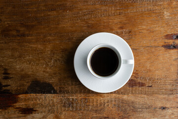 Coffee on a wooden table. Flat lay with negative space.