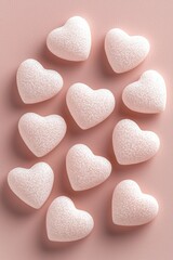 Obraz premium heart emotion minimalist romance. Delicate pink heart-shaped candies arranged artistically on a soft pink background.
