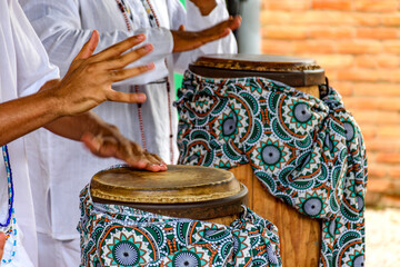 The atabaque being played by percussionists during a religious festival in Umbanda