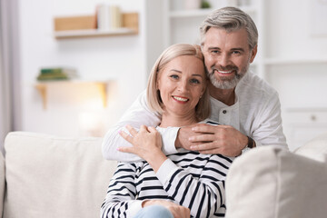Portrait of happy middle aged couple at home