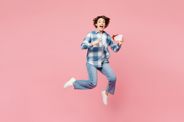 Full body young happy woman she wear blue shirt white t-shirt casual clothes jump high hold gift...