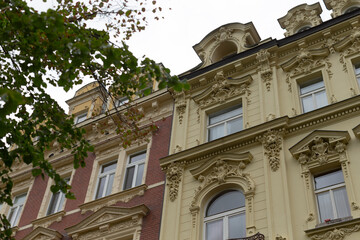 The historic building facade beautifully showcases a variety of unique architectural styles and intricate details that reflect its rich heritage and cultural significance within the city