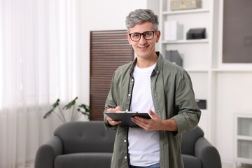Portrait of professional psychologist with clipboard in office, space for text