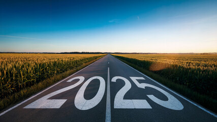 A vibrant photograph of a long, straight road stretching towards a bright horizon. The road is beautifully framed by lush fields of tall, green crops. Bold, large white letters spell out "2025" along 