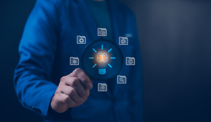 Businessman holding a magnifying glass that illuminates a light bulb icon, representing insight, innovation, and the search for bright ideas in the corporate world. Business solution idea concept.