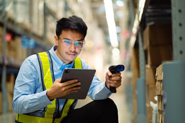 A man in a safety vest is using a tablet to scan a barcode. He is smiling and he is enjoying the task