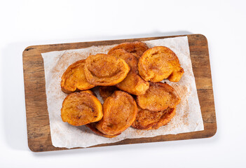 Traditional brazilian christmas Rabanadas with egg yolk crea and cinnamon, Spanish Torrijas on soft wood isolated on white background, top view.