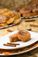Traditional brazilian christmas Rabanadas with egg yolk crea and cinnamon, Spanish Torrijas on white plate.