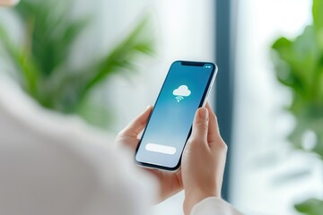 Hands holding a smartphone displaying a cloud storage app interface, representing digital connectivity and data management.