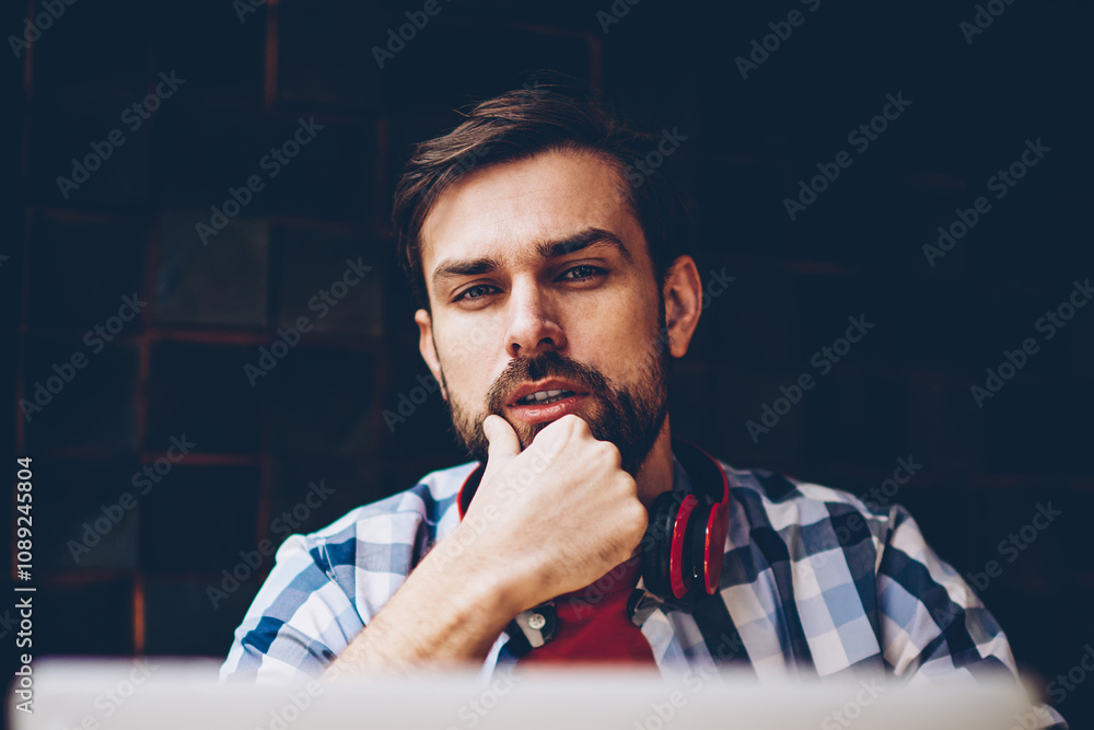 Poster portrait of handsome bearded hipster guy working on freelance and using wireless 4g internet connect